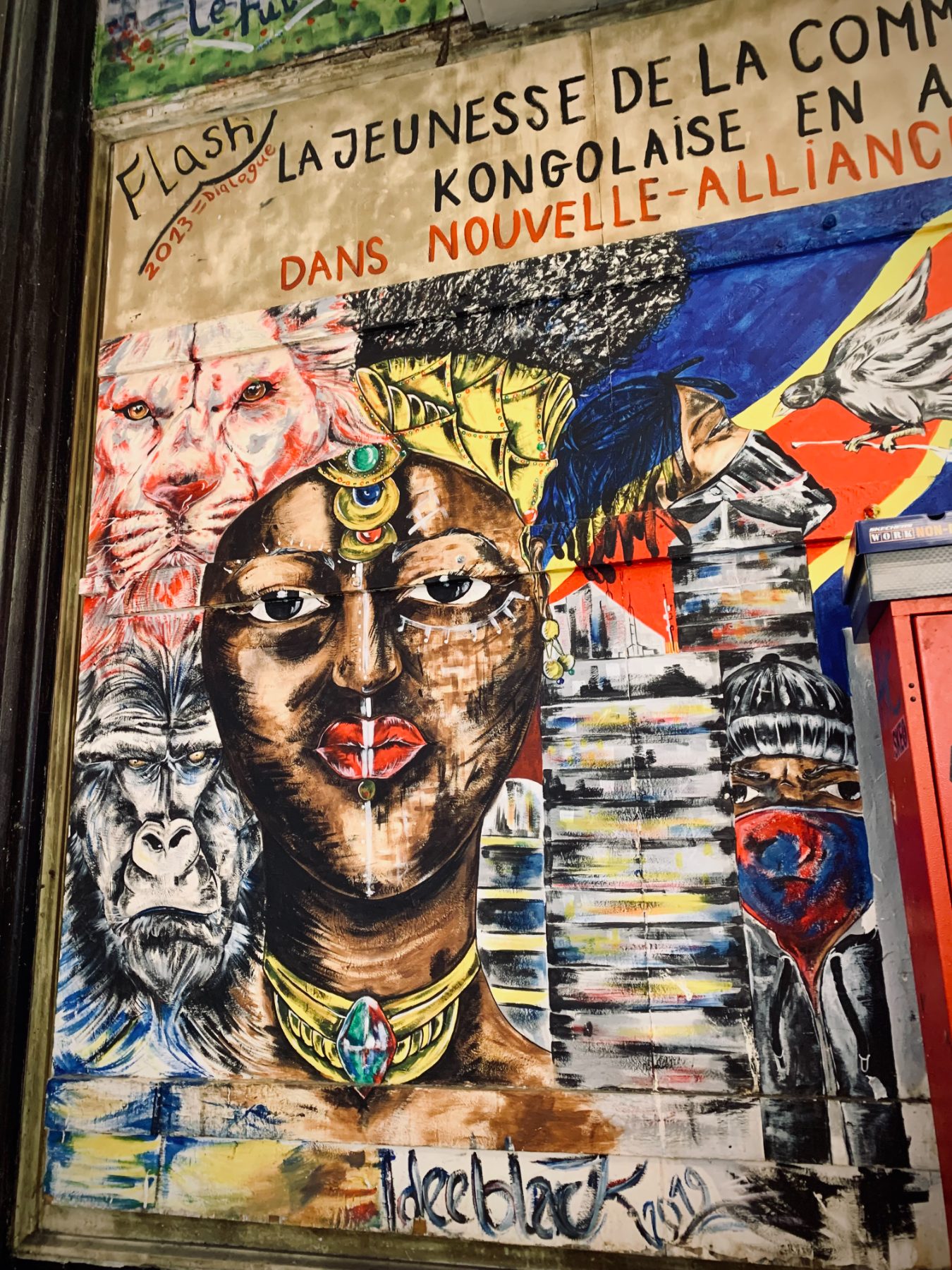 A painted mural of an African ancestral face