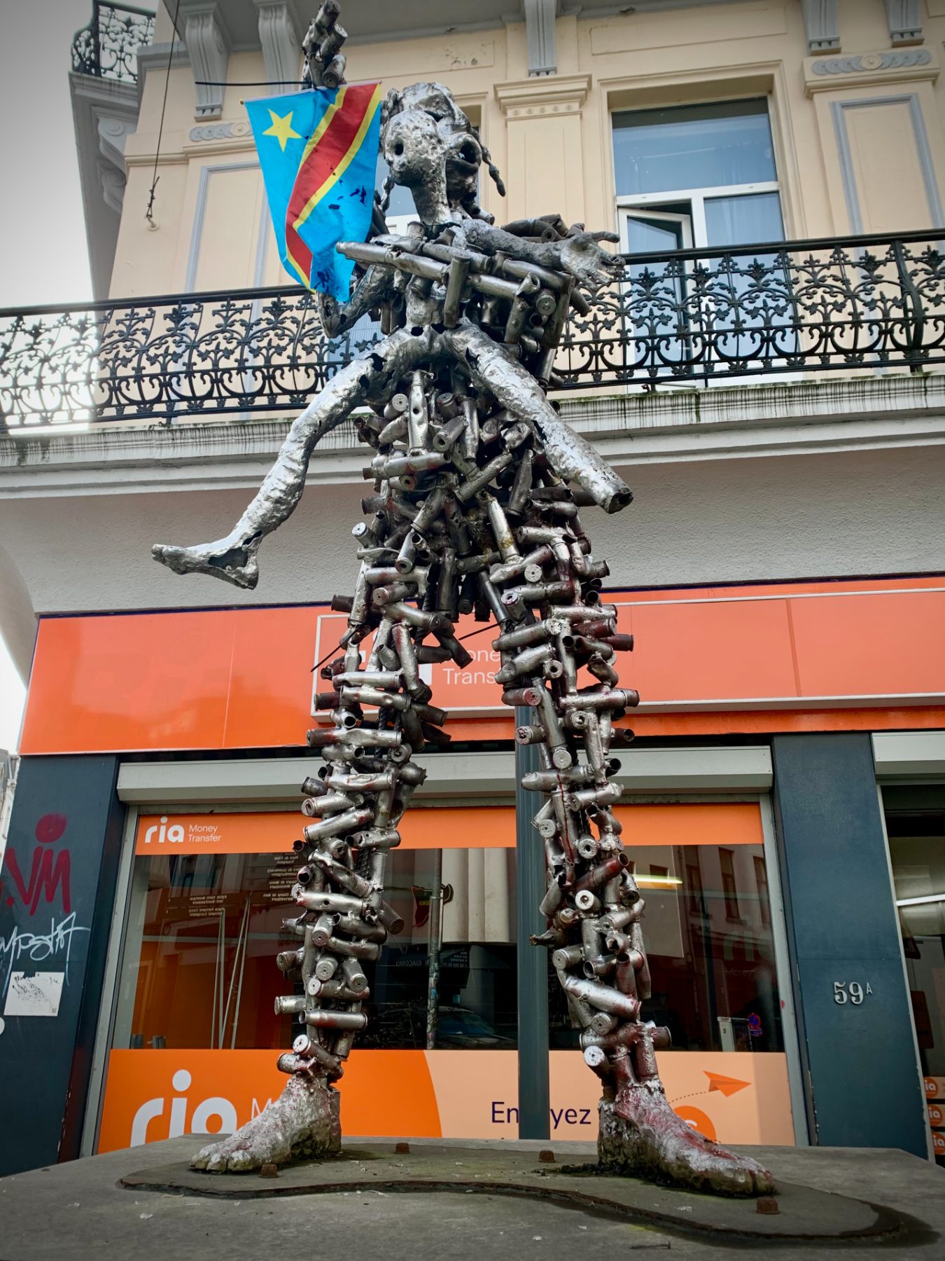 A human figure assembled from many small metal parts